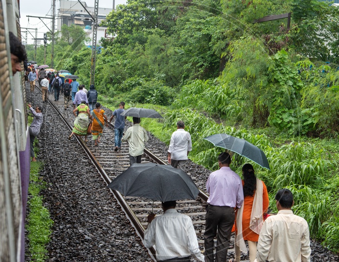 Train commuters take to the track as goods train derails ahead on the tracks