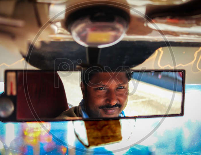 taxiwala looking in the mirror of taxi