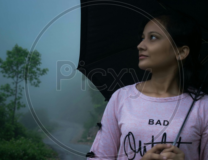 Portrait of girl holding umbrella