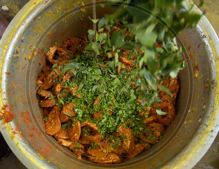 Adding Curry Leaves in Fish Recipe