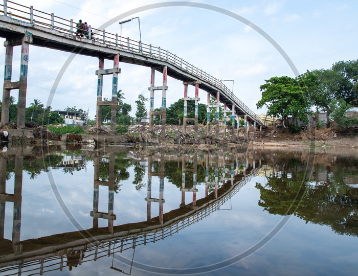 commuters using the small bridges on Buckingham Canal on Revendrapadu Bridge, Andhra Pradesh, India
