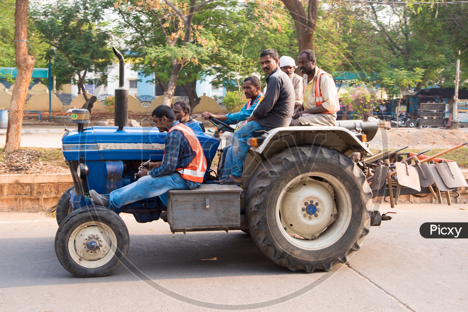 HMDA Workers & Gardeners riding on a tractor