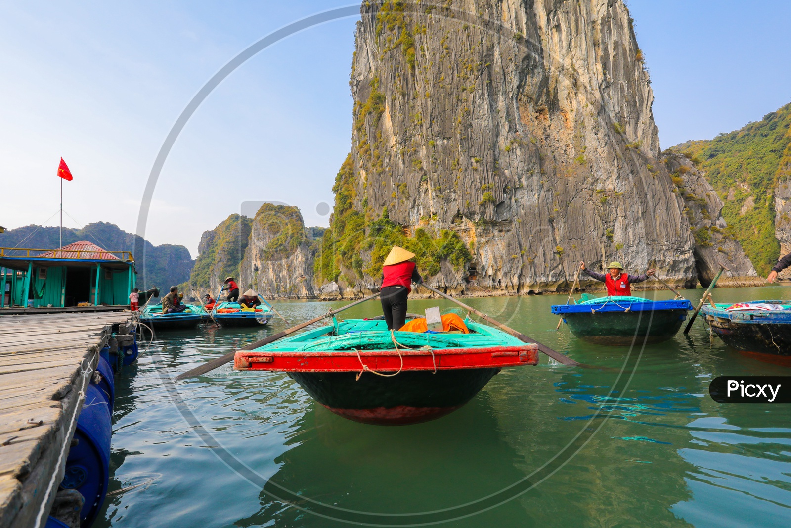 Rowers waiting for tourist passengers on Bamboo Boat at Halong Bay, Vietnam.
