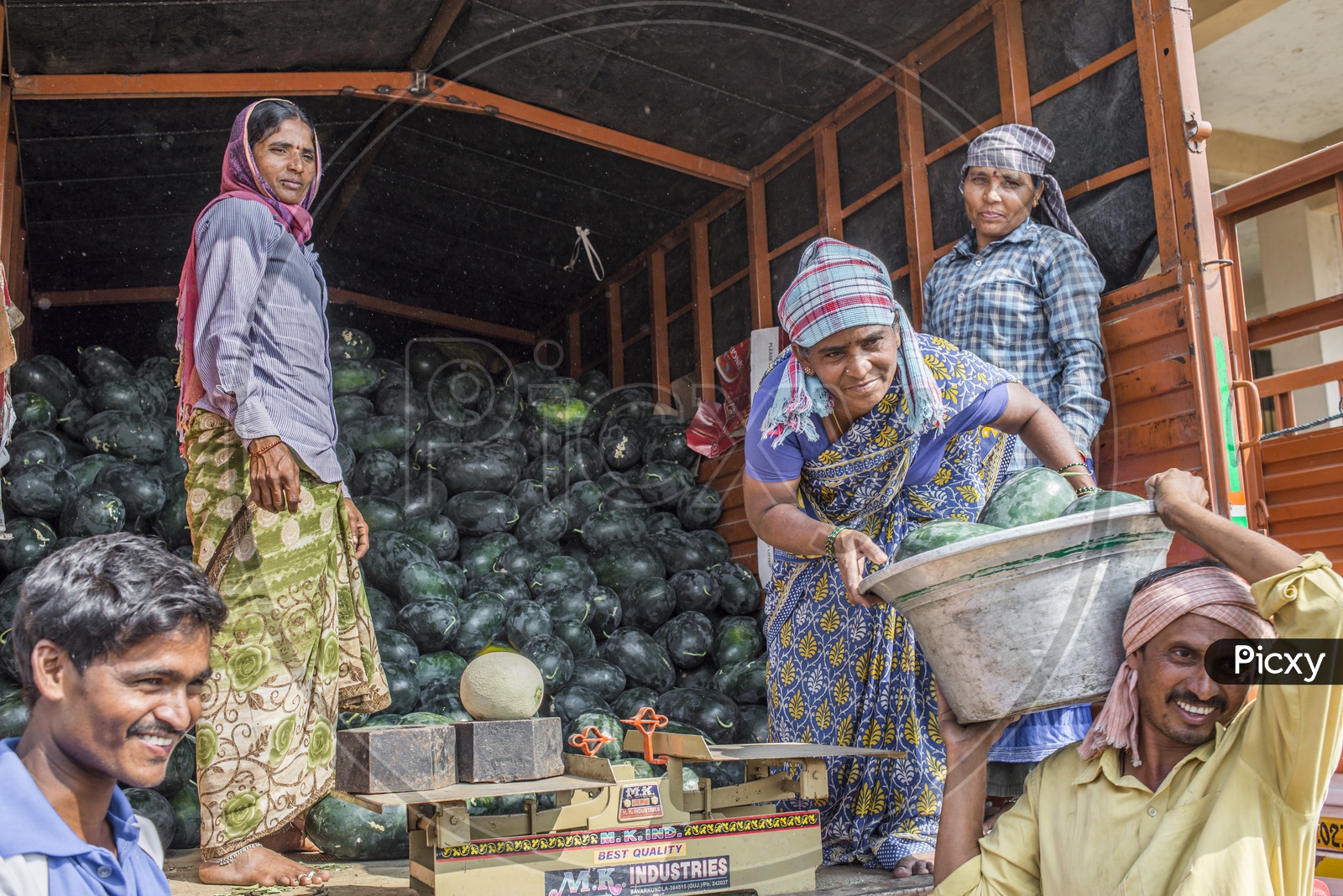Female workers unloading watermelon in Kothapet Fruit Market, Hyderabad