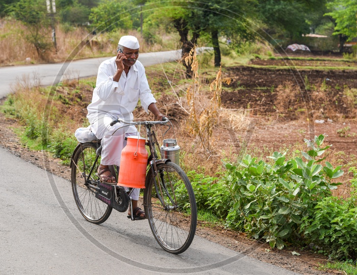 Milkman in remote village of Maharashtra communicating on Mobile Phone