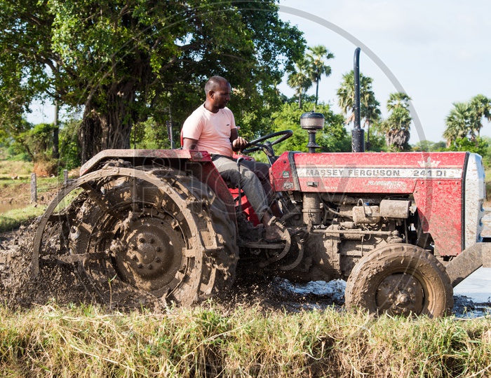 Farmer using modern technology to plough fields