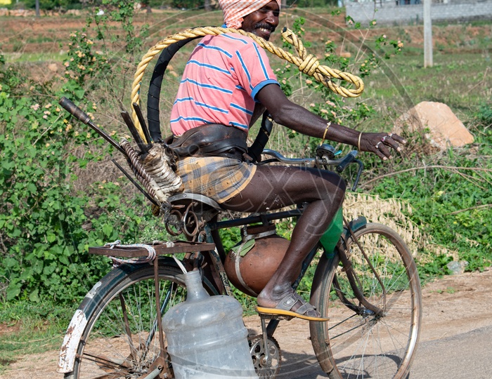 Toddy farmer on a bicycle