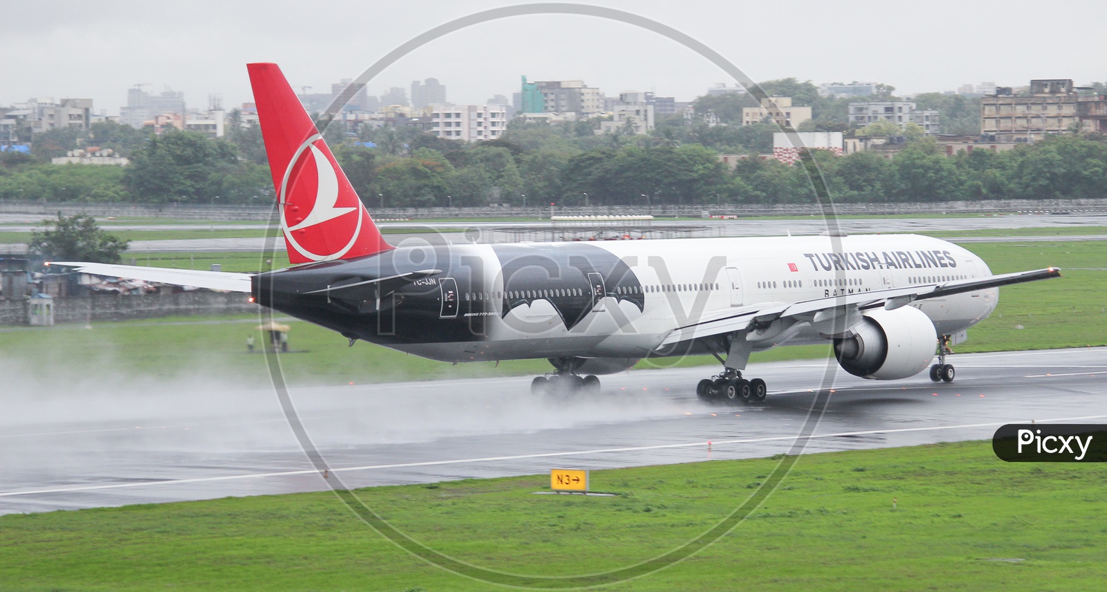Turkish airline B777-300ER drying up the wet runway.