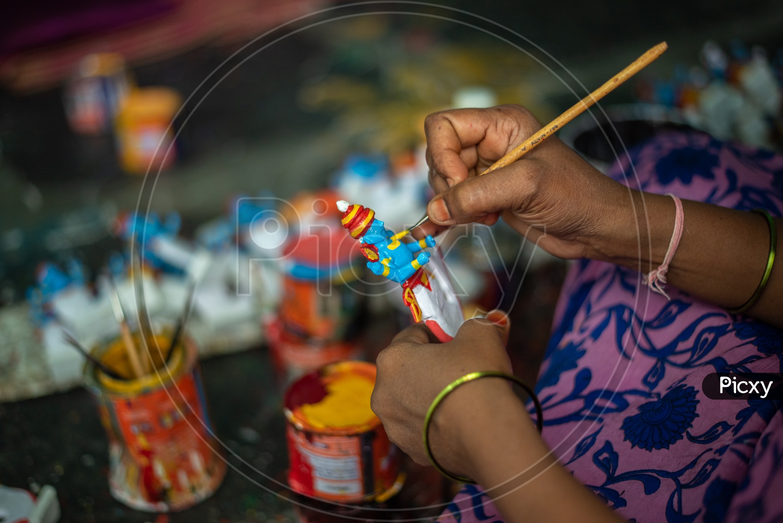 A woman painting Kondapally Toy/Bomma