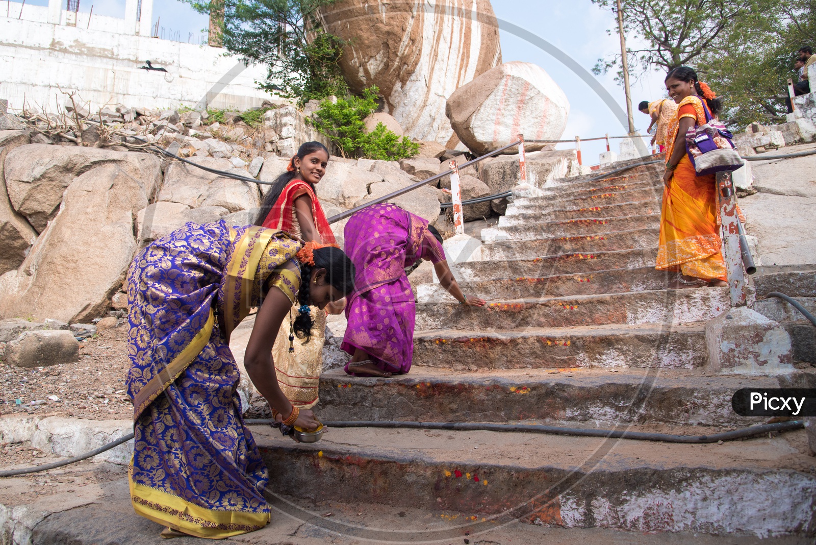 Pilgrims applying vermilion to steps of Yadagiri temple