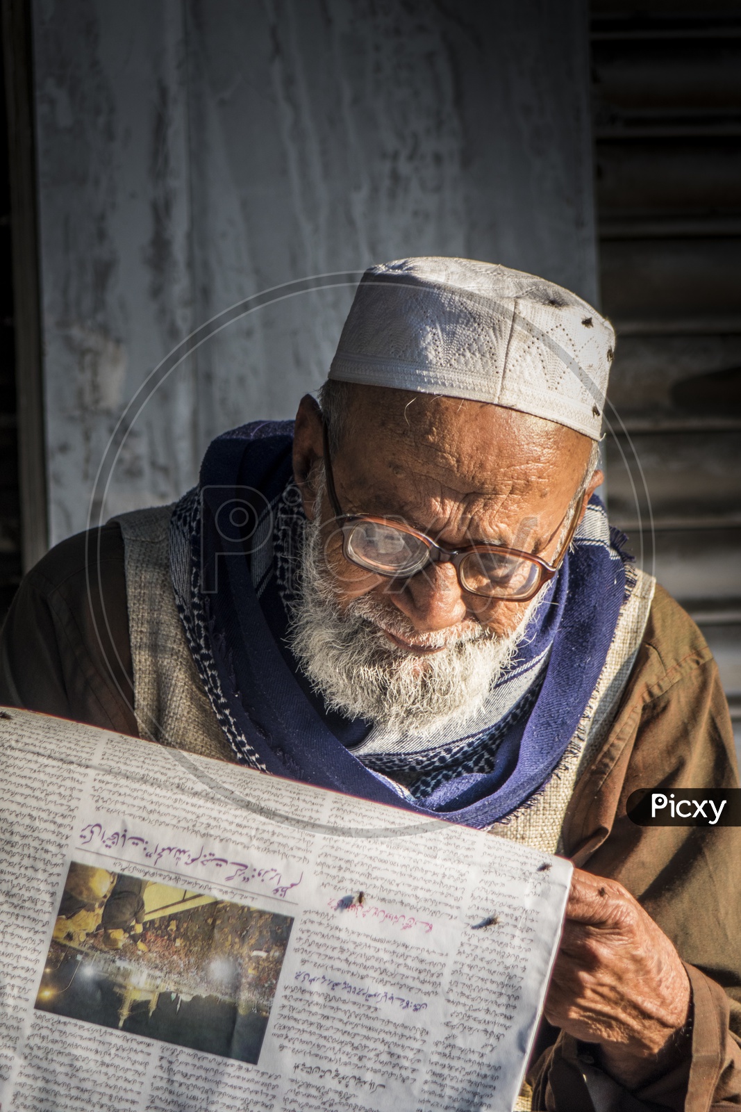 Old Muslim Man reading News paper