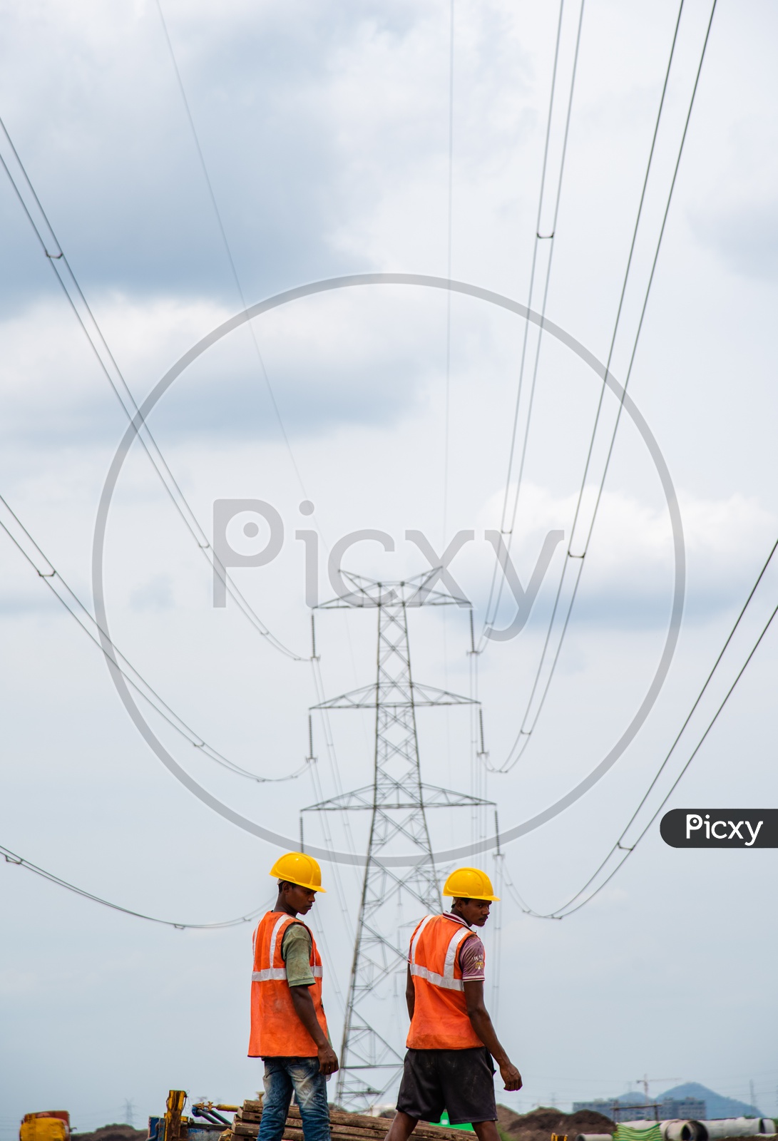 Construction Workers under High Voltage Electricity Wires.