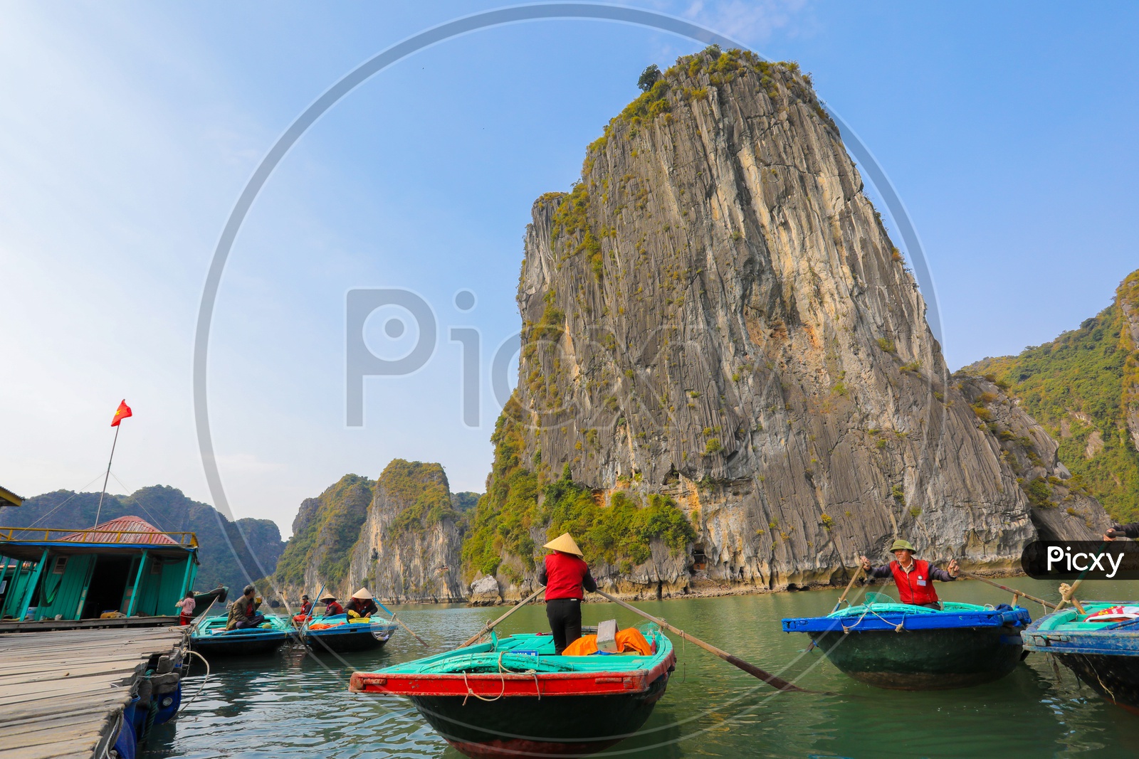 Rowers waiting for tourist passengers on Bamboo Boat at Halong Bay, Vietnam.
