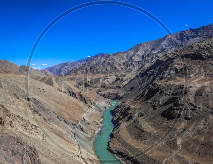 Indus River flowing amidst Hills and Mountains of leh ladakh