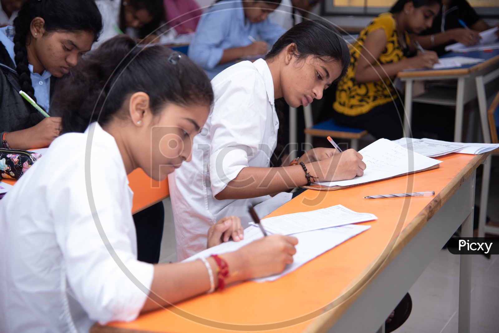Girl students writing exam at an educational institute.