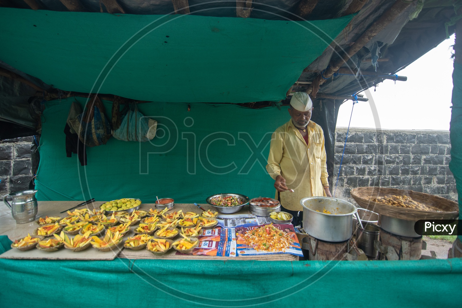 Vendor selling mangoes, peanuts and other food items at Sinhagad Fort