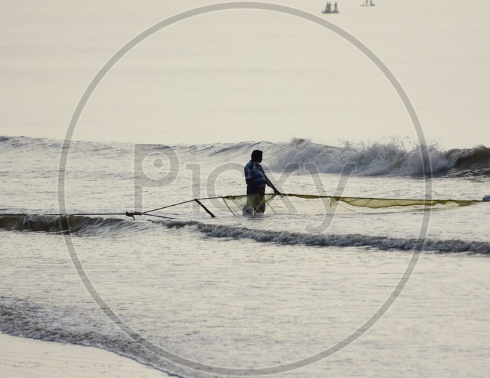 Fisherman with fishing net in Kakinada Beach