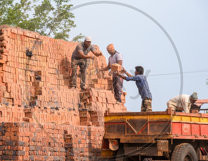 Loading Red Bricks on to Tractor