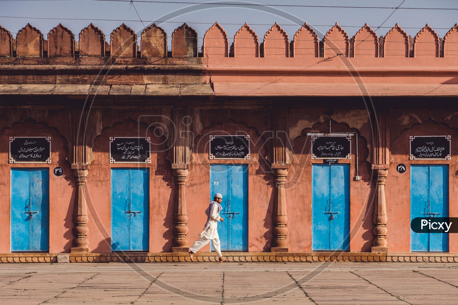 A boy jogging around at Taj Ul Masjid , Bhopal, Madhya Pradesh.