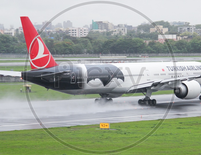 Turkish airline B777-300ER drying up the wet runway.