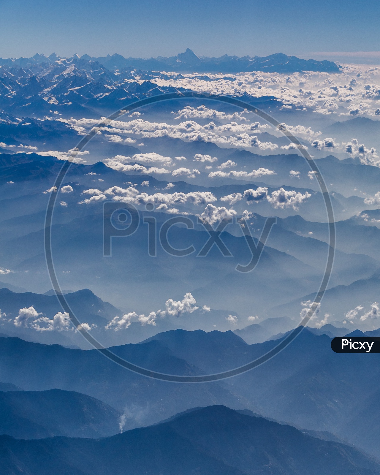 Clouds over Snow capped Mountains of Himalayas