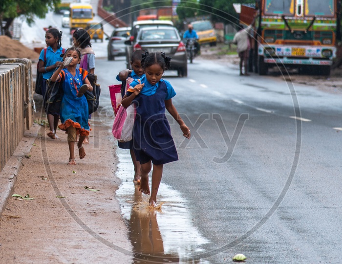 government school students/girls playing in monsoon
