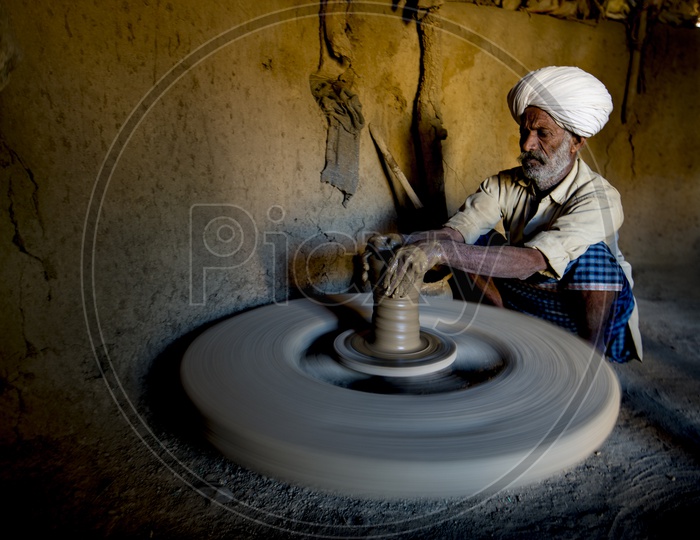Old Man Making Clay Pot on Pottery Wheel in Ajmer