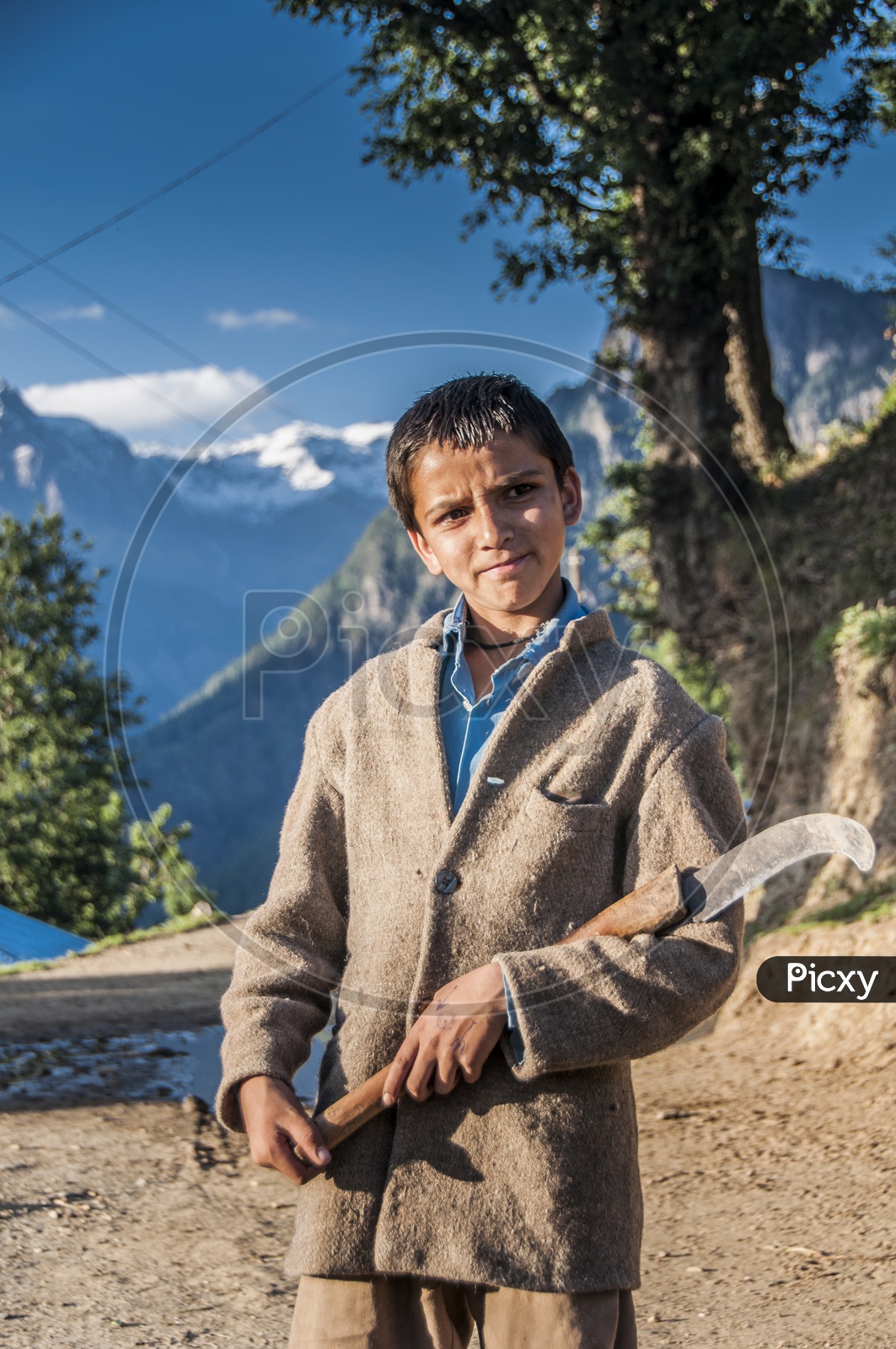 Kid with working tool in Kwar Village, Himachal Pradesh