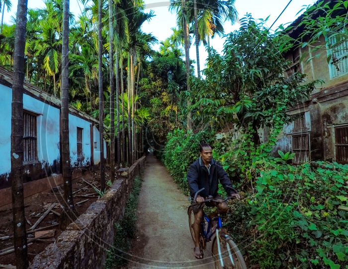 A man riding his bicycle at Konkan