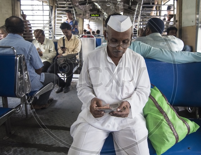 Local Maharashtra Man counts currency in a local train