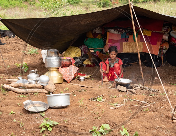 A little girls cooks meal for their family of shepherds in Maharashtra