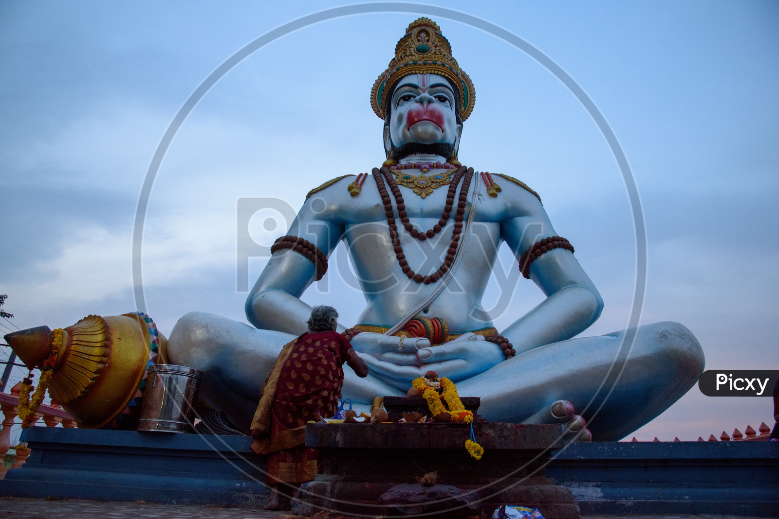 A woman praying to Hanuman