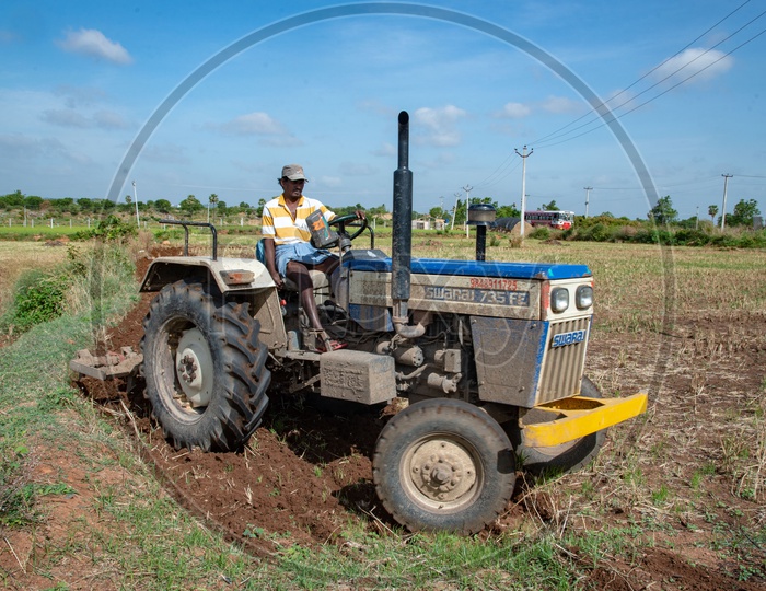 Farmer working on fields on tractor