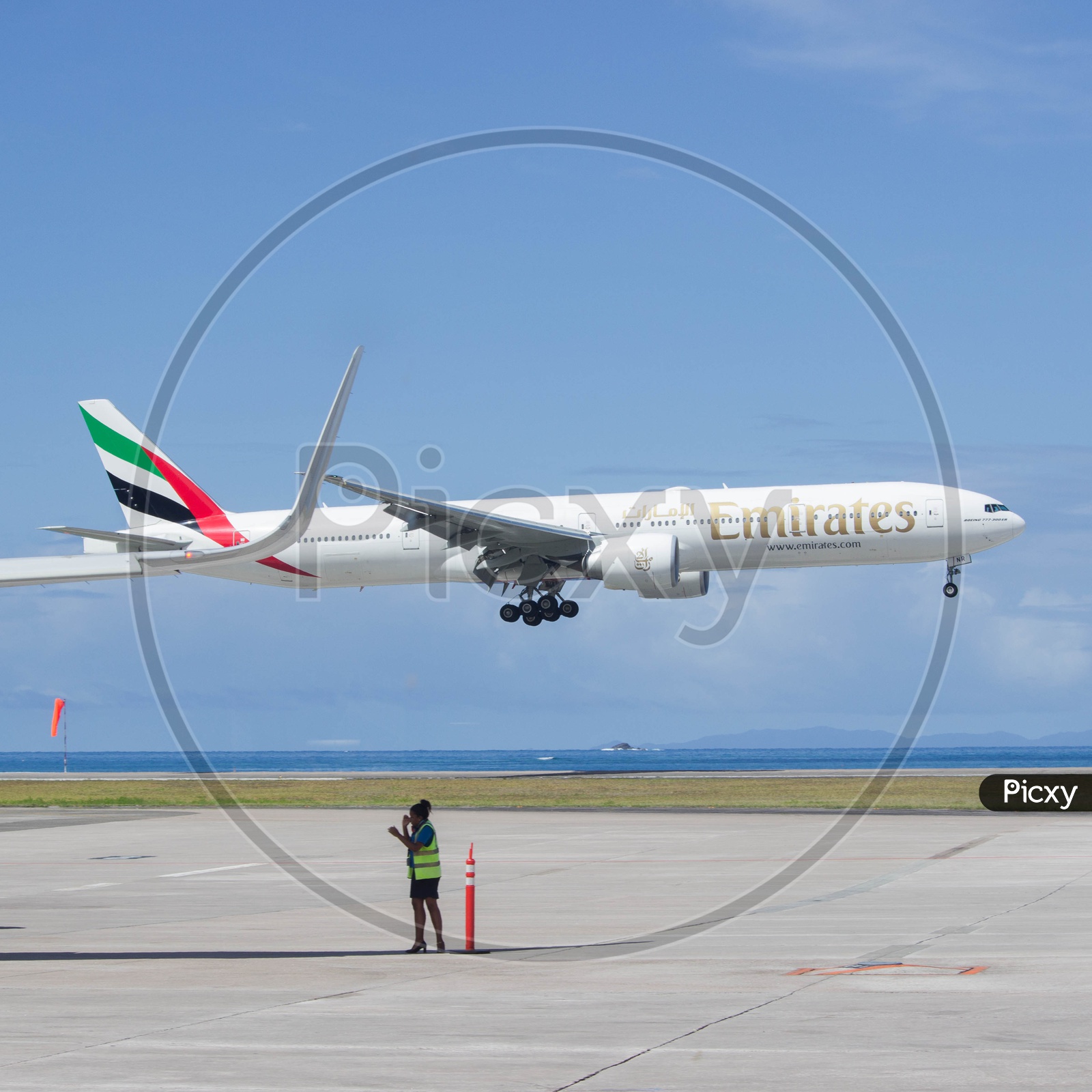 Emirates B777-300ER landing in paradise.