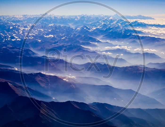 Clouds over Snow capped Mountains of Himalayas