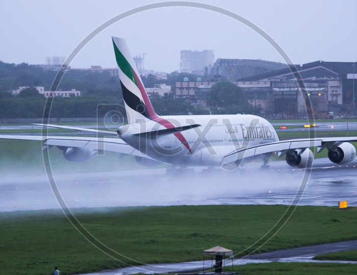 Emirates A380 splashing water off from the rwy.