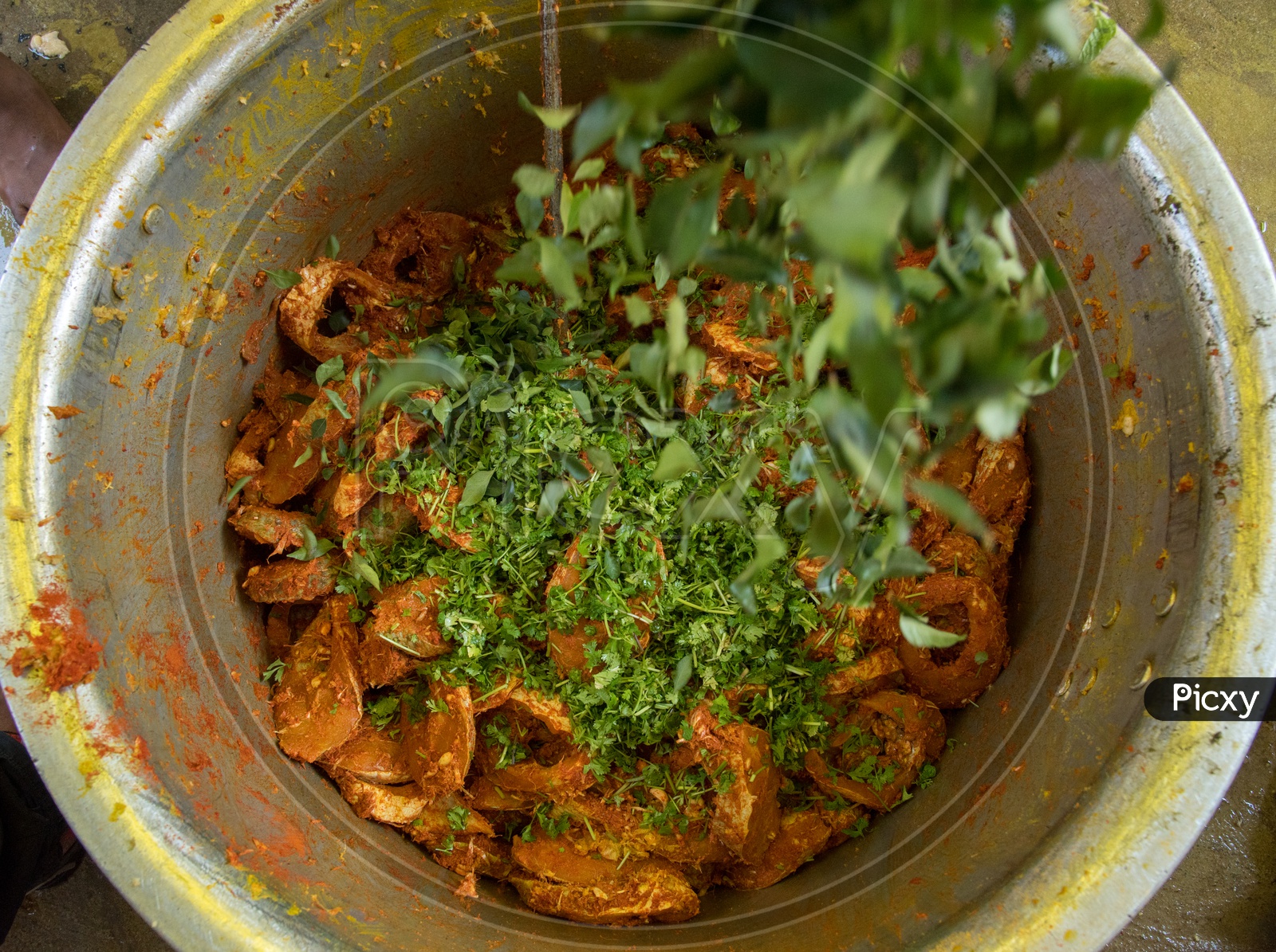 Adding Curry Leaves in Fish Recipe