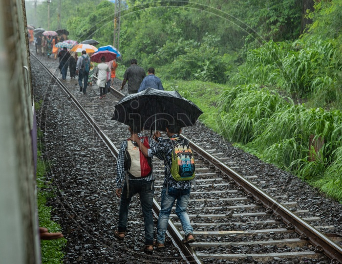 Passengers take to the tracks to reach the nearest station as train breaks down