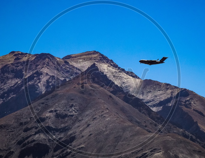 An aeroplane flying above the Hills and Mountains of Leh ladakh