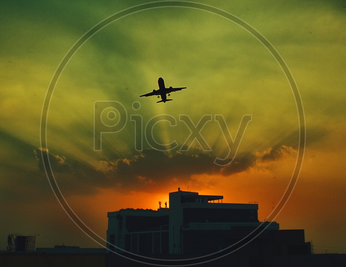 Silhouetted Aeroplane flying over the sky
