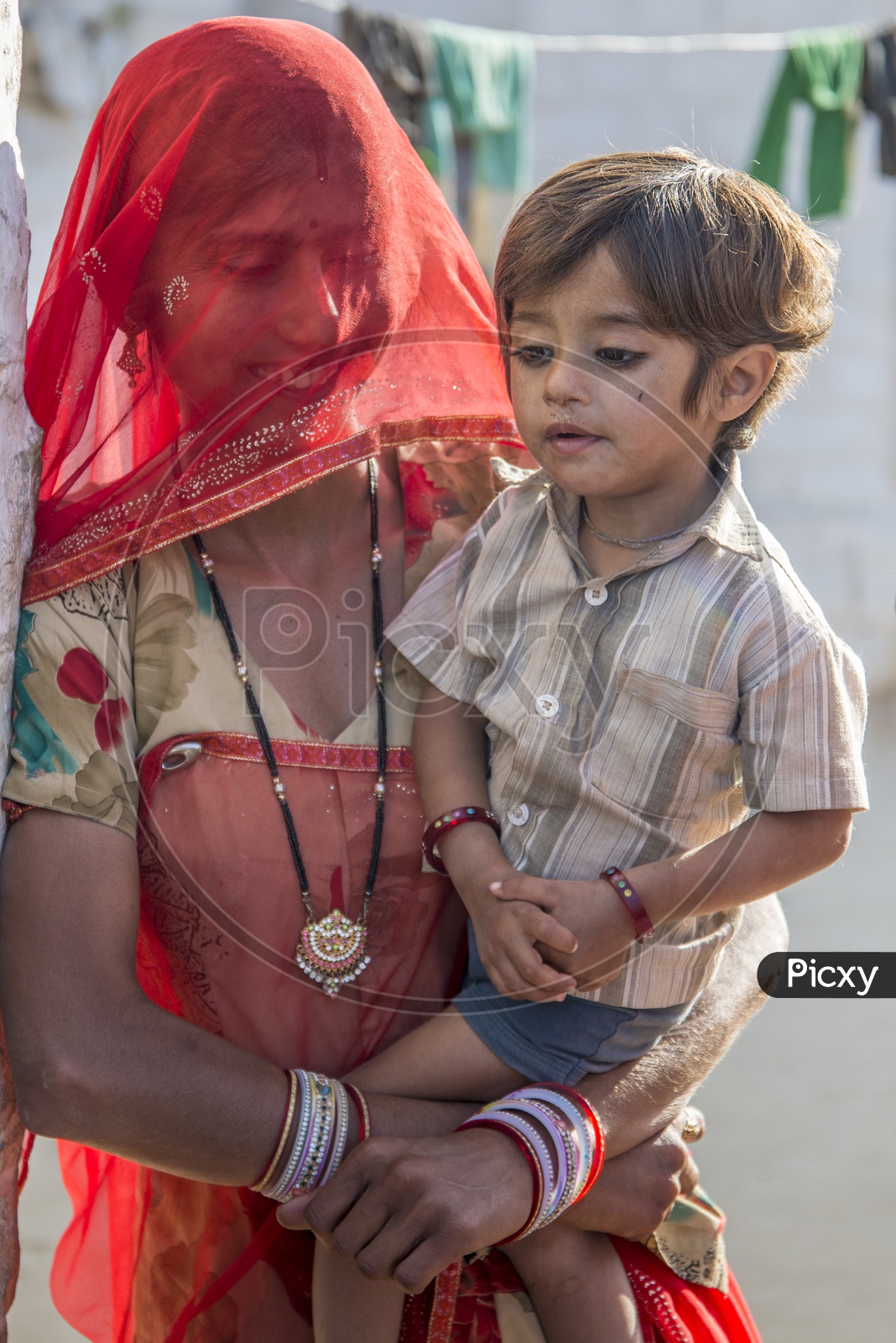 Smiling Rajasthani Woman with her Son in Traditional Attire