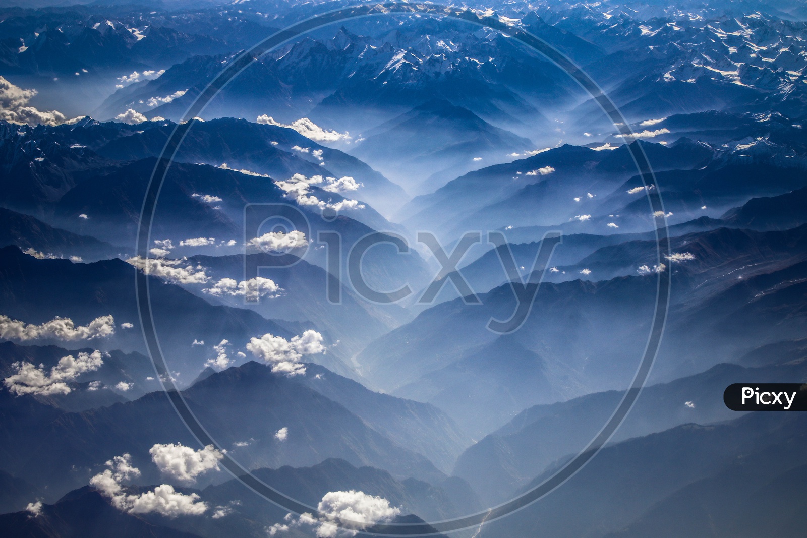 Layer like structure formation of Hills and Mountains of Himalayas with clouds above them