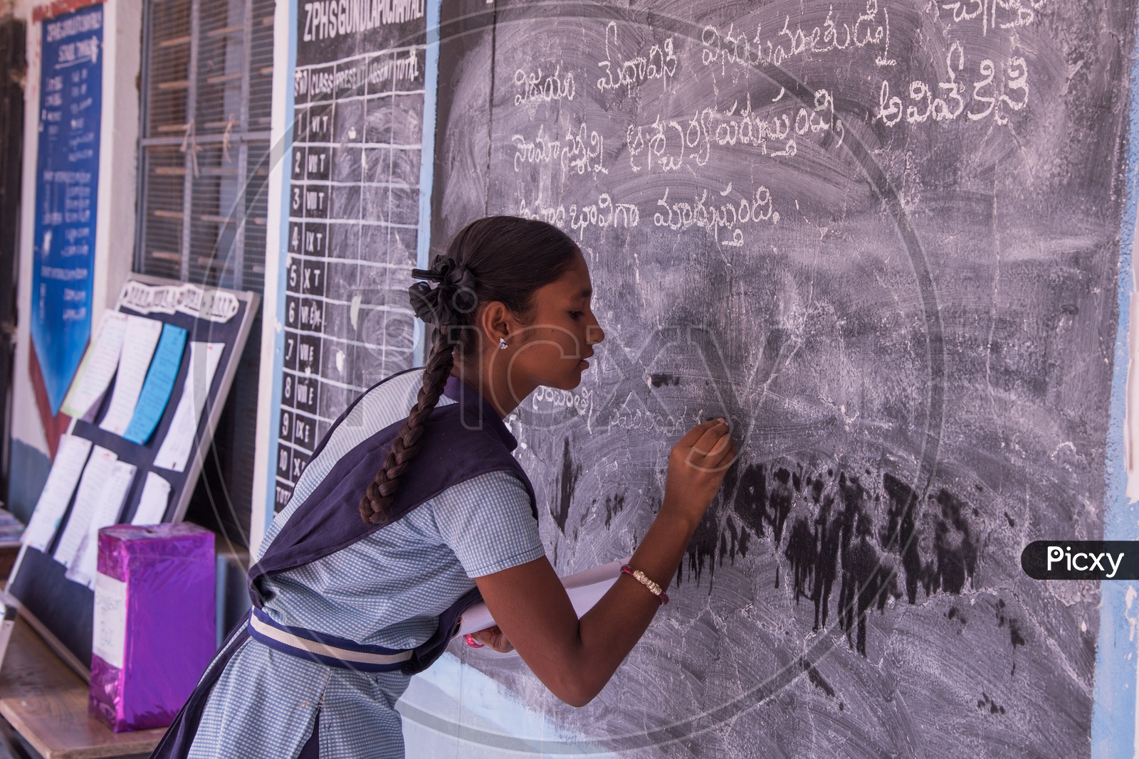 Student at Govt School writing on Black Board