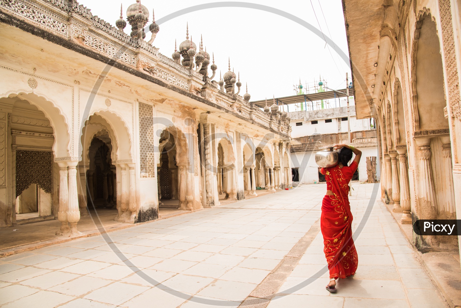 A women carrying water for their household needs at Paigah tombs.