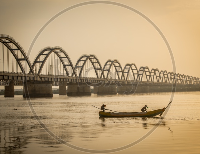 A Silhouette of Godavari Arch Bridge and A Fisherman