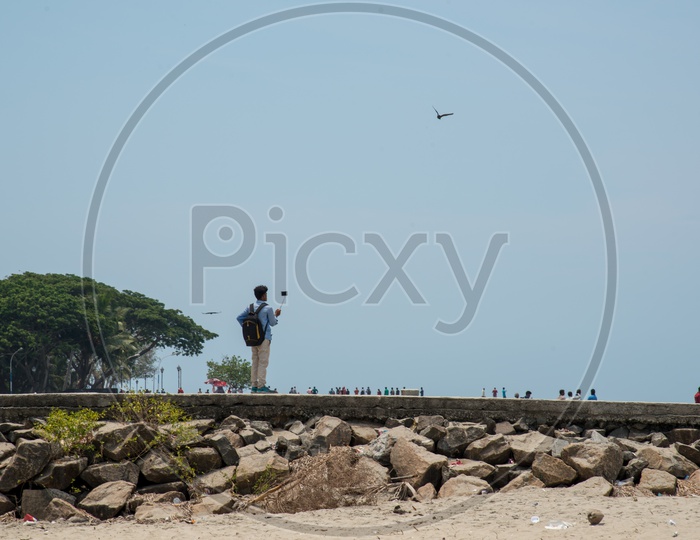 A tourist documenting Fort Kochi Beach,Kerala.