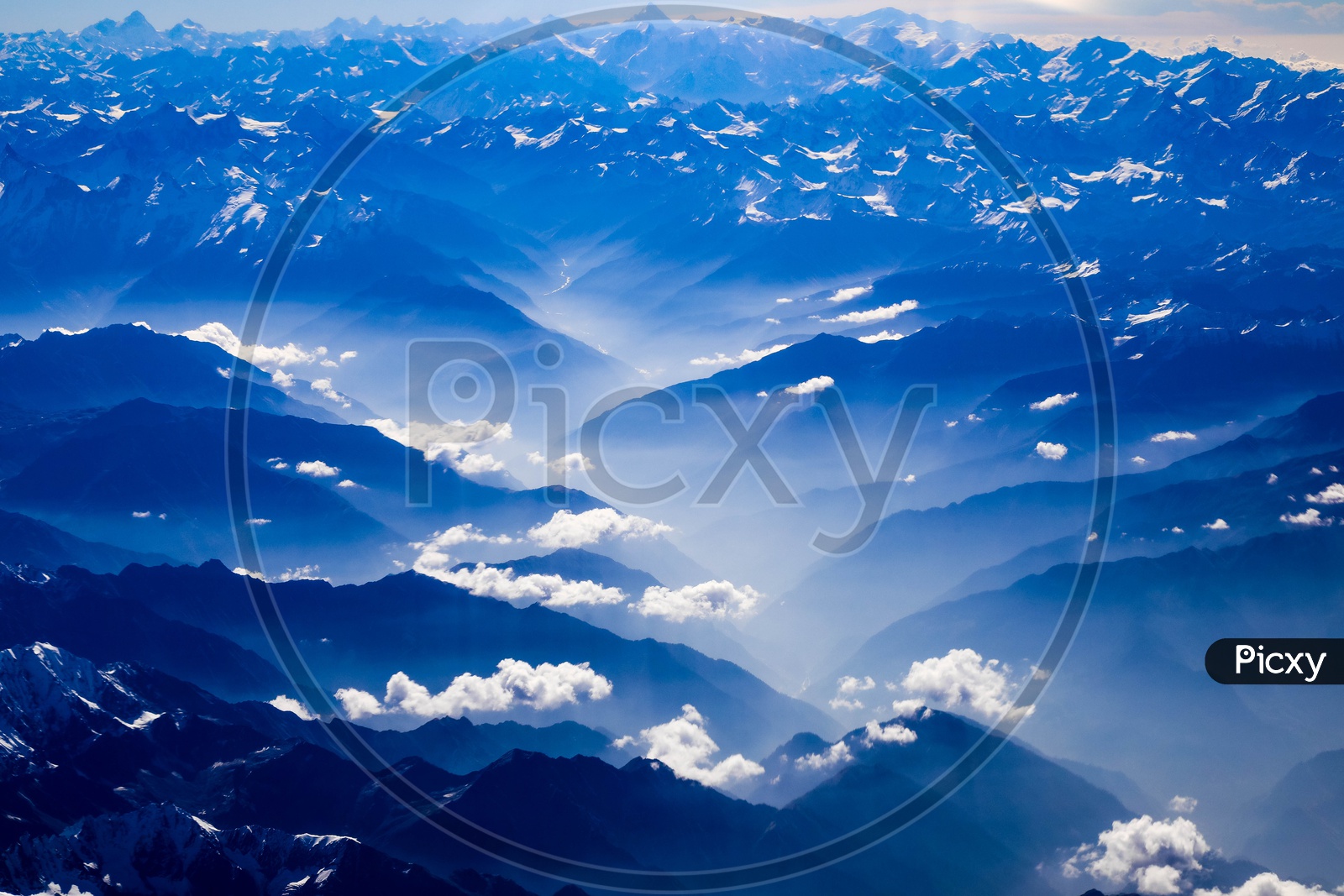 Layer like structure formation of Hills and Mountains of Himalayas with clouds above them