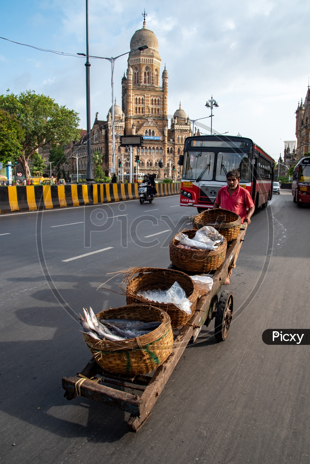 Fisherman carries his cart on busy Mumbai CST Circle