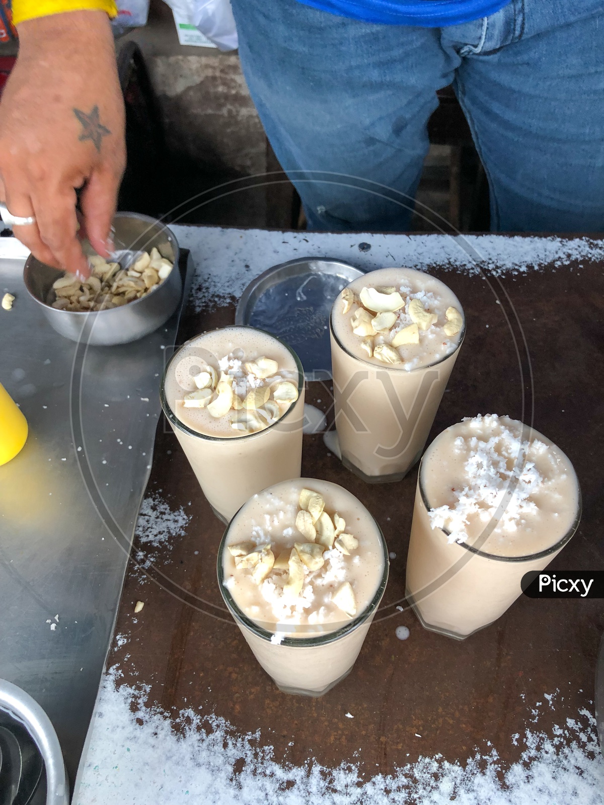 Cashew and fresh coconut being added to Lassi