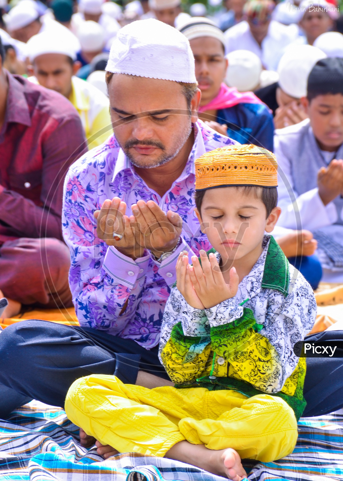Father and Son offering prayers during Eid